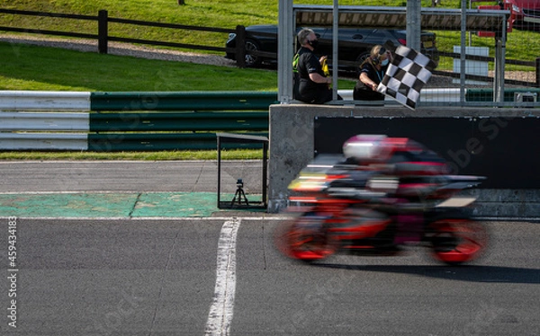 Fototapeta A shot of a racing motorbike as it circuits a track.