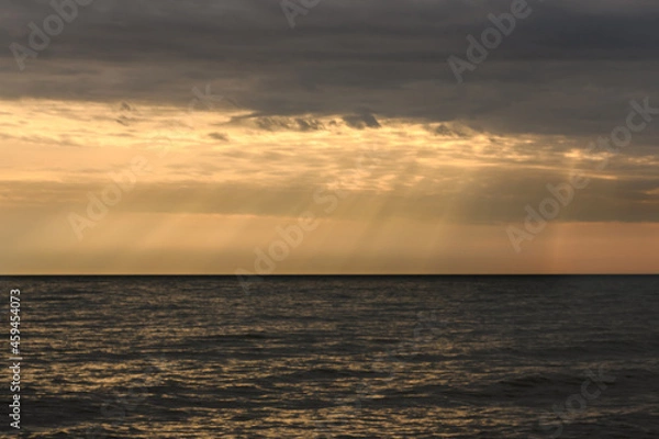 Fototapeta Cloudy sunset over Baltic Sea. Looks like rays from heaven