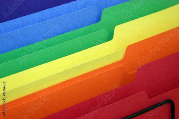 Fototapeta rainbow colored tabbed file folders in a basket