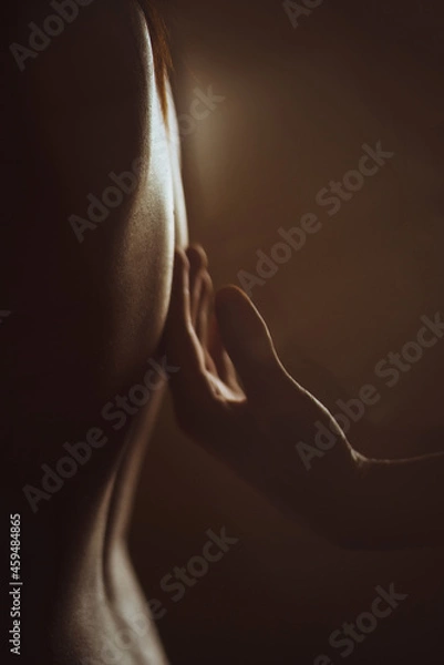 Obraz Man's hand gently strokes a woman's back