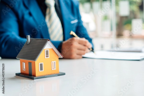 Fototapeta Buying a Home or Insurance, an insurance agent explains the lease agreement to a client before making a contract. Mortgage loan approval home loan and insurance concept.