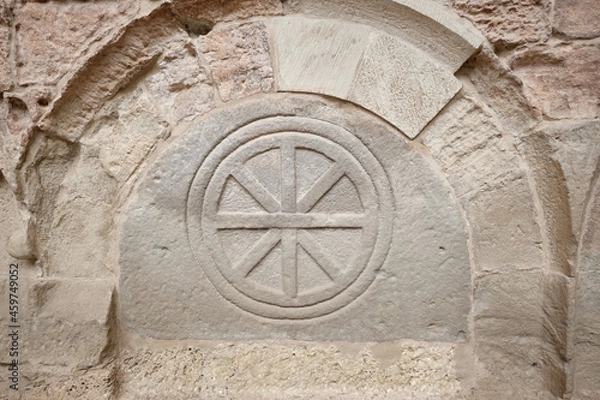 Fototapeta San Juan de la Peña, Aragon September 7, 2021, Wheel in a Sepulcher in the Pantheon of the monastery of San Juan de la Peña