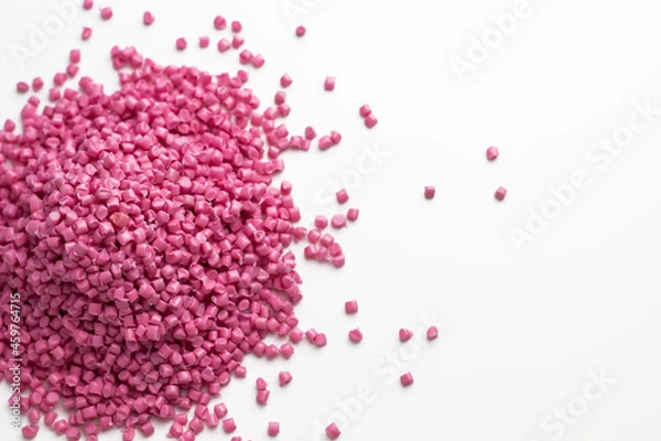 Obraz Pink granules of polypropylene or polyamide on a white background. Plastics and polymers industry. Copy space.