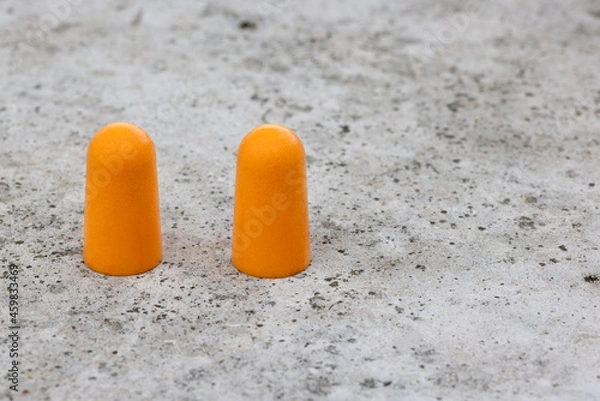 Obraz Two orange soft foam ear plugs with copy space