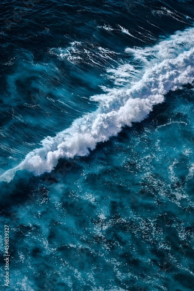 Fototapeta Aerial view to seething waves with foam. Waves of the sea meet each other during high tide and low tide