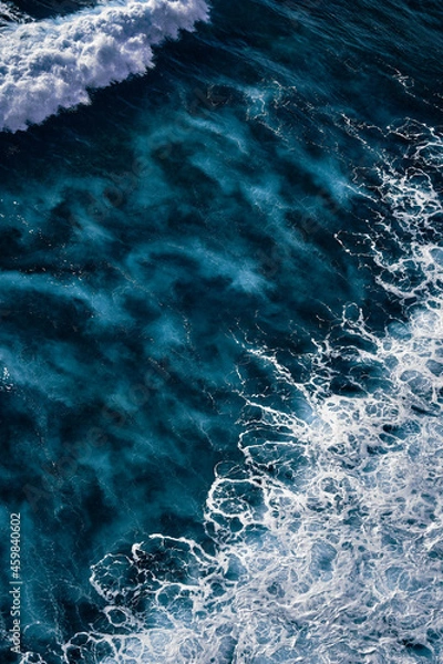 Fototapeta Aerial view to seething waves with foam. Waves of the sea meet each other during high tide and low tide