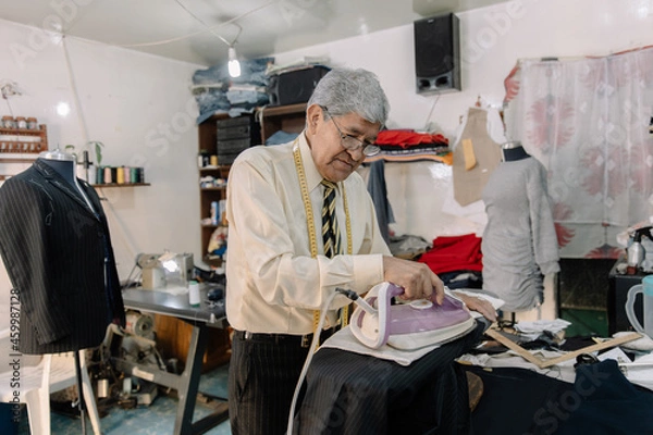 Obraz experienced mexican tailor ironing clothes
