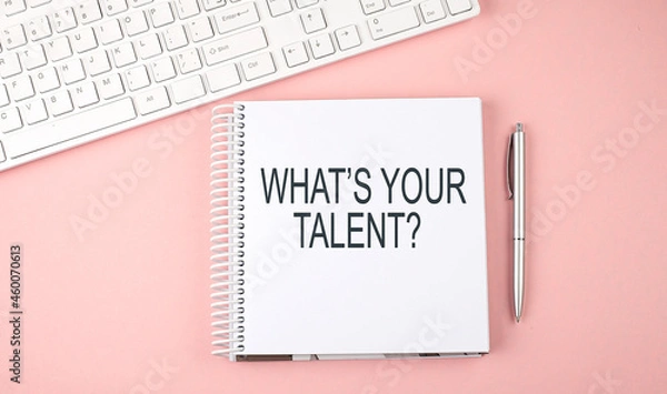 Fototapeta Pink office desk with keyboard and notebook with text WHAT'S YOUR TALENT