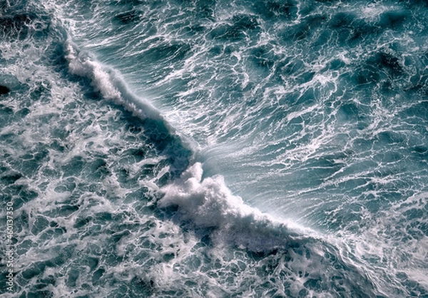 Obraz Aerial view to seething waves with foam. Waves of the sea meet each other during high tide and low tide
