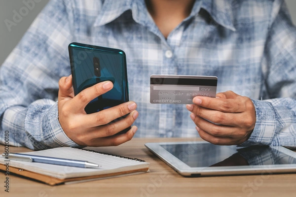 Fototapeta Business woman hands holding credit card and using mobile smart phone , online shopping, woman happy.