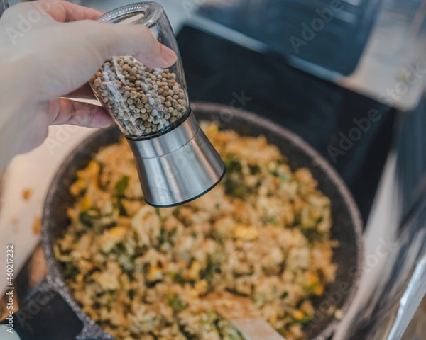Obraz Pepper bottle for stir fried rice with kale ,egg, onion in a pan for cooking.