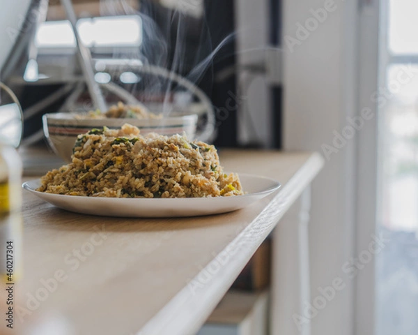 Obraz Stir fried rice with chicken ,kale ,onion, egg in a white plate on the wood table for cooking.