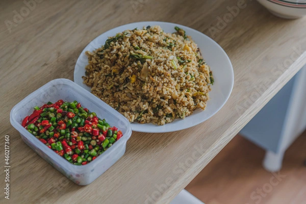 Obraz Stir fried rice with fish sauce and chili on wood table for eating.