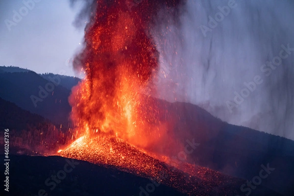 Fototapeta Volcano eruption in evening in mountains