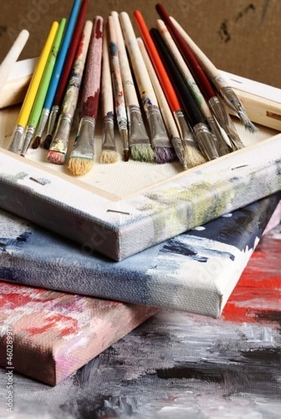 Obraz Various paint brushes on painted canvas 

