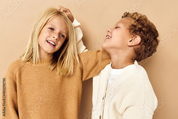 Fototapeta boy and girl smiling and posing in casual clothes isolated background