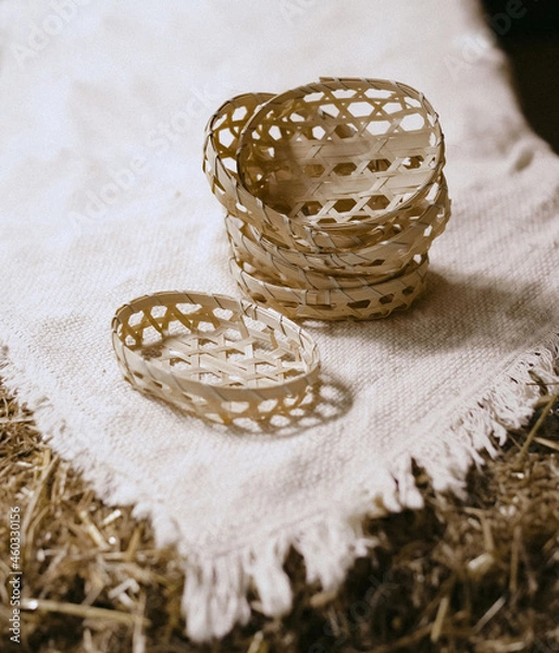 Obraz Wicker baskets on white linen tablecloth
