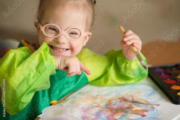 Obraz Girl with Down syndrome covered in paint when drawing