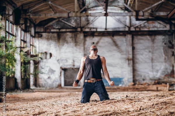 Obraz Young Strong but Broken Man Crying in Despair on his Knees