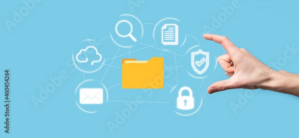 Obraz Document Management System DMS .Businessman hold folder and document icon.Software for archiving, searching and managing corporate files and information.Internet Technology Concept.Digital security