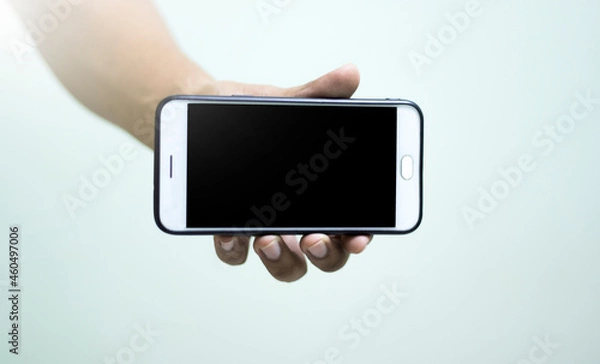 Obraz A full white mobile phone is in the hands of the people.