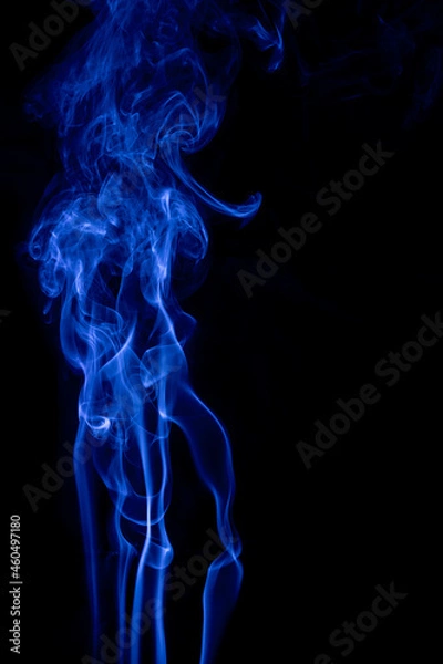Obraz The movement of blue smoke faces a fierce fierce black background on abstract things on a black background.