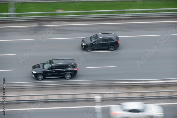 Fototapeta the car goes fast along the road.  movement and speed.  the rhythm of the city, the flow of time and business.  design of a booklet, album, website.