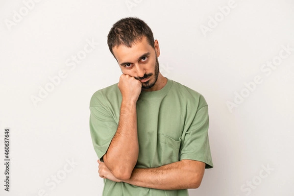 Fototapeta Young caucasian man isolated on white background who feels sad and pensive, looking at copy space.