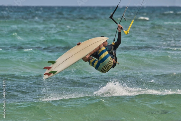 Fototapeta Wind surfer taking risk while surfing in the seas of the Caribbean