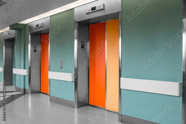 Obraz orange elevator door on contrasting walls