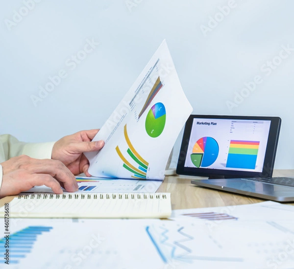 Obraz man working data graph document near notebook, tablet, laptop