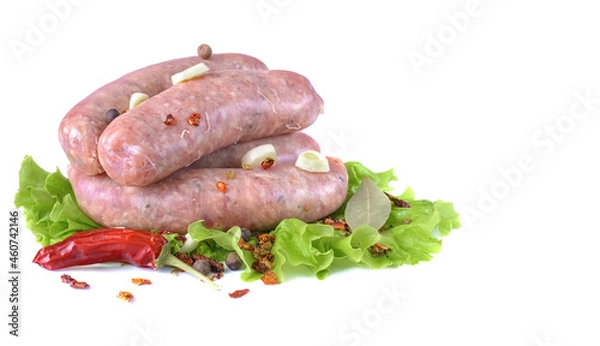 Fototapeta Raw pork sausages.Grilled sausages in close-up, isolated on a white background.Selective focus.