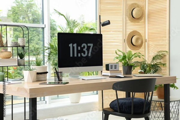 Fototapeta Comfortable workplace with computer in light room. Interior design