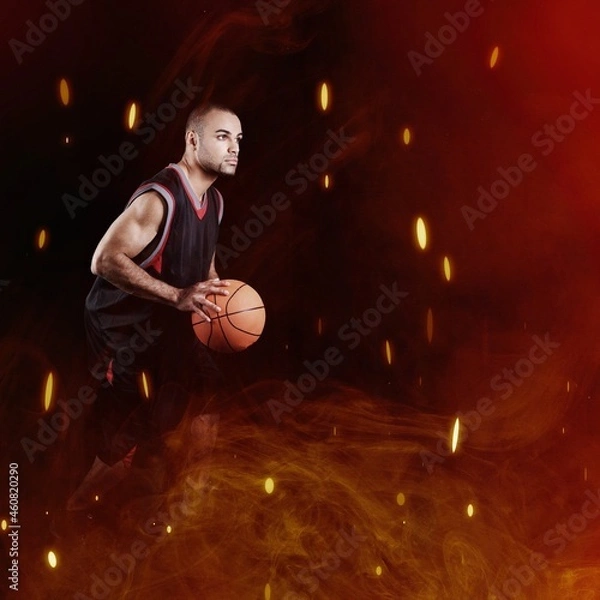 Fototapeta High jumping. Young man, a male basketball player in explosion of fire