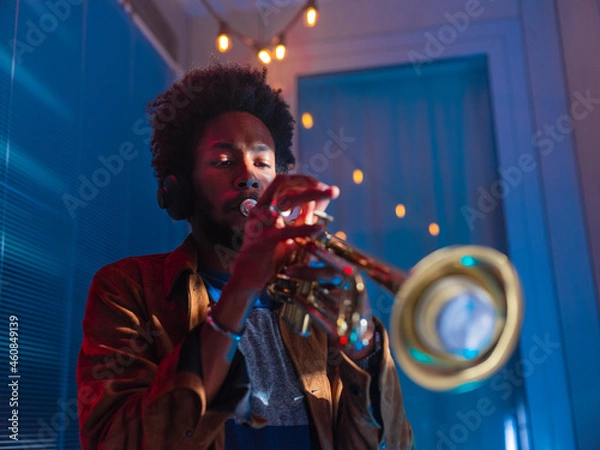 Fototapeta Young trumpeter performs at home