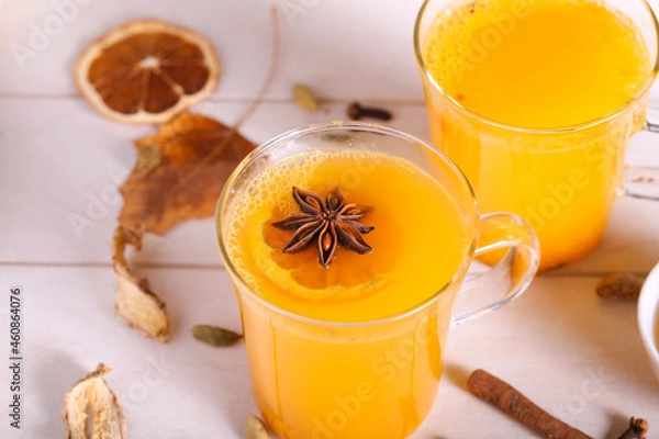 Fototapeta Tea with sea buckthorn and spices is on the table