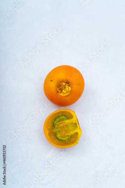 Obraz Lulo and a half on a marble background, orange fruit