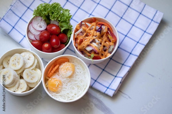 Obraz Take away healthy food in foil boxes on marble table.