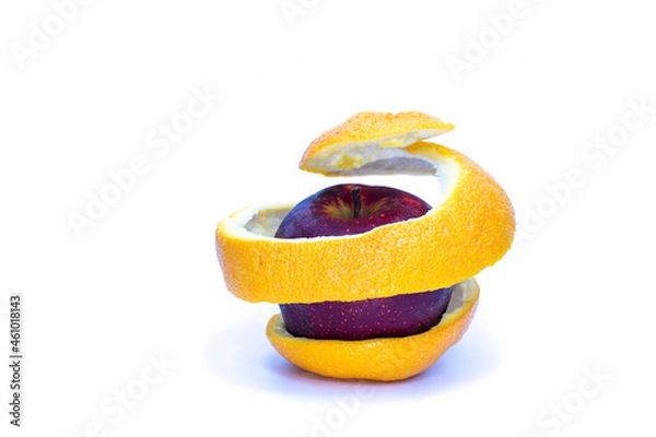 Fototapeta red apple in orange peel spiral on white background