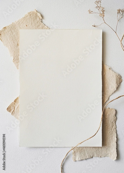 Fototapeta Handmade paper and dry flowers. Christmas Mockup for showcasing artwork and design. Minimal winter mockup of letterhead or drawing paper. Flat lay.