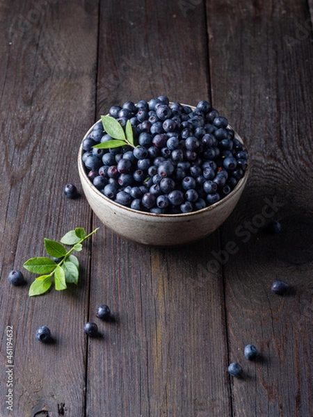 Fototapeta Blueberry bowl on wooden background with copy space in rustic style