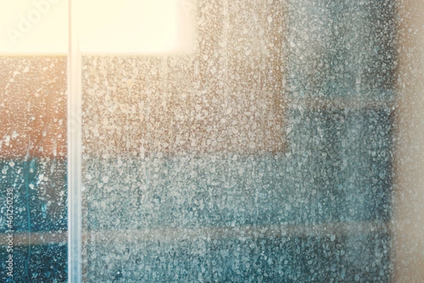 Obraz Removing hard water stains and deposits in bathroom. Stains drops on glass shower doors