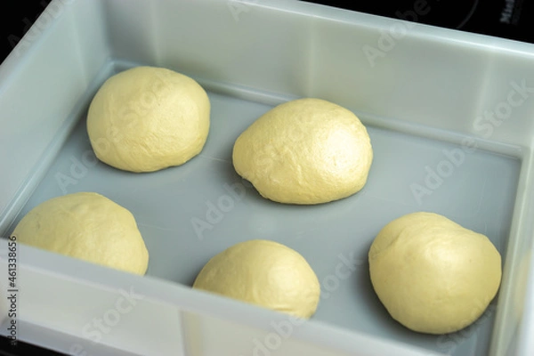 Obraz Pizza dough in a plastic tray.