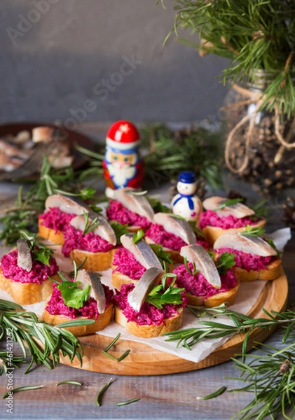 Obraz Sandwiches with beets and herring. New Year's snack with fish. Christmas food. Appetizing on New Year's Eve