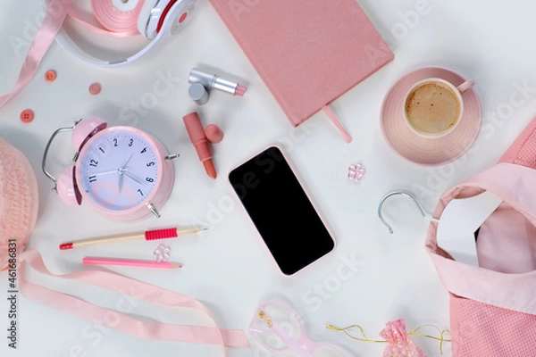 Fototapeta womens stylish accessories, smartphone with blank screen, glamorous set in pink shades, flat lay, copy background, womens clothing, alarm clock, lipstick, coffee cup, good morning concept, female life