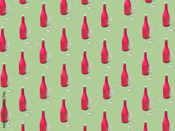 Fototapeta Christmas pattern made with pink champagne bottle and glass on bright light green background. Minimal Christmas party concept. Christmas isometric pattern, background, banner.