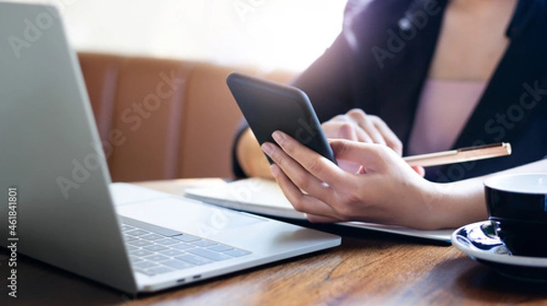 Obraz E learning concept. Casual business woman using smartphone working or study online with laptop computer and lecture on notepad.