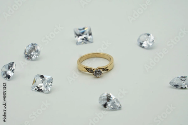 Obraz gold ring surrounded by diamonds on white background
