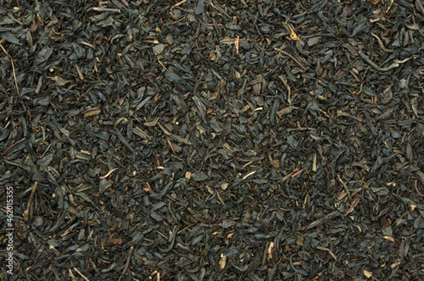 Fototapeta Black tea leaves top view backdrop. close-up detail background