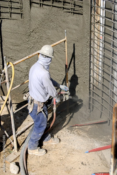 Fototapeta Construction worker operating a shotcrete pressure hose and nozzle